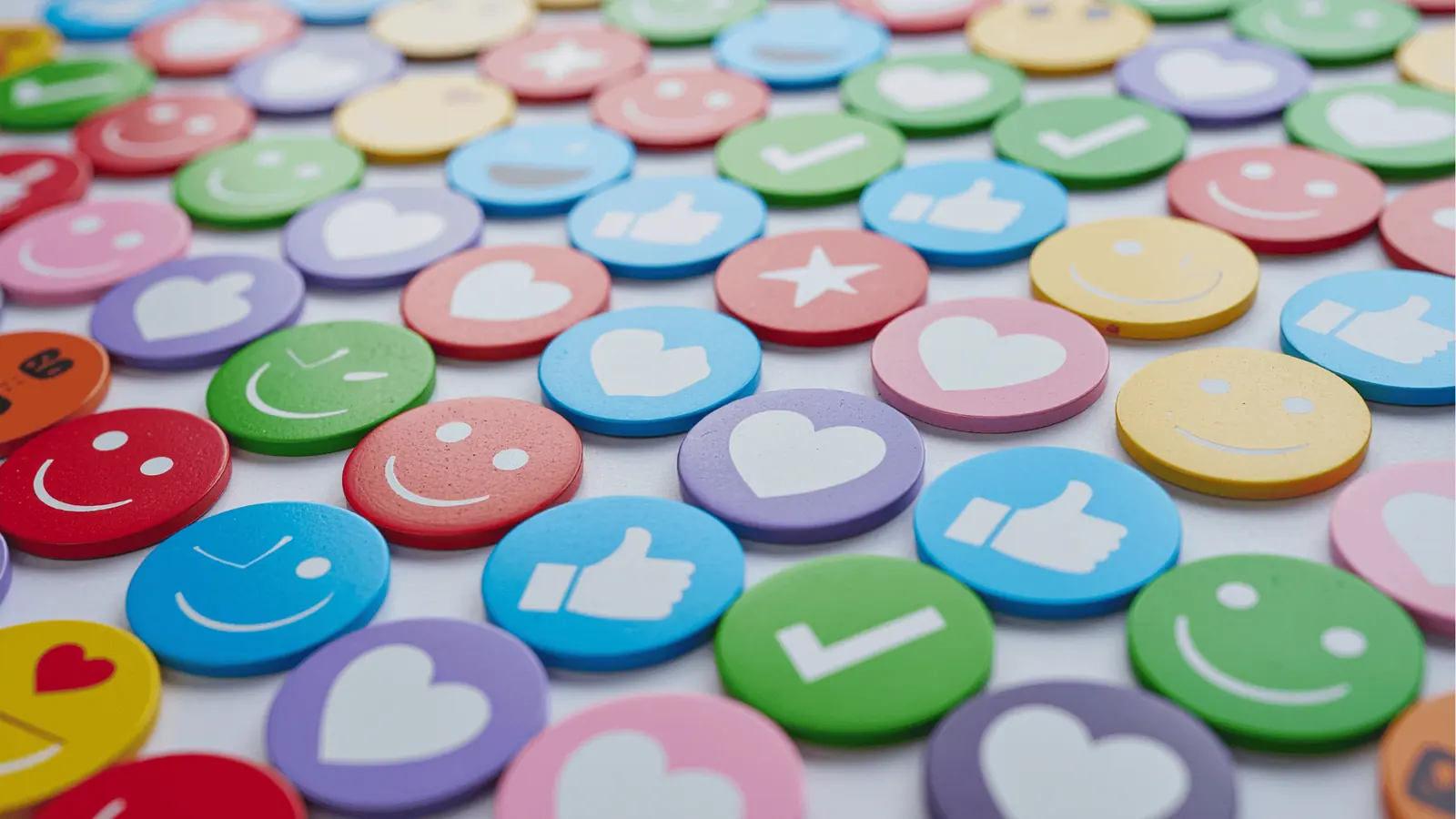 Colorful round tokens with hearts, thumbs-up, checkmarks and smiley faces
