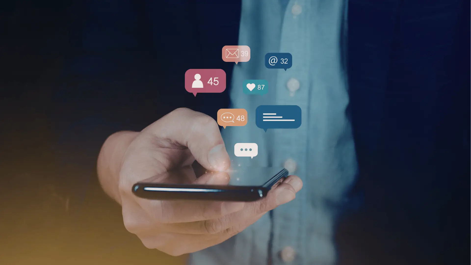 Close-up of hand holding smartphone with floating social notification icons