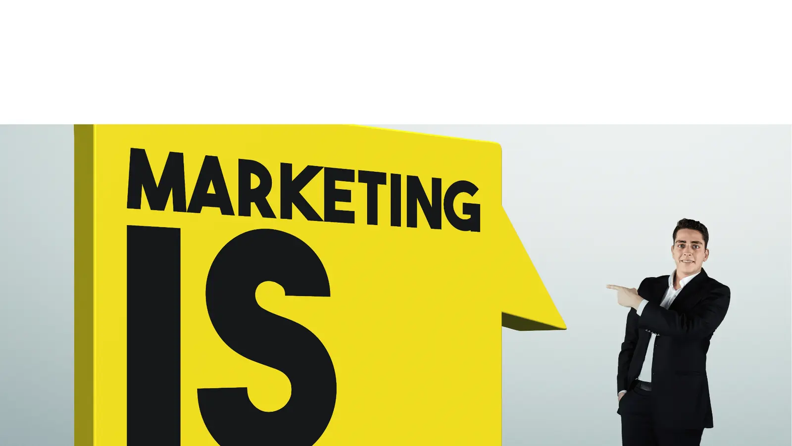 Man in suit pointing at large yellow sign that reads MARKETING IS