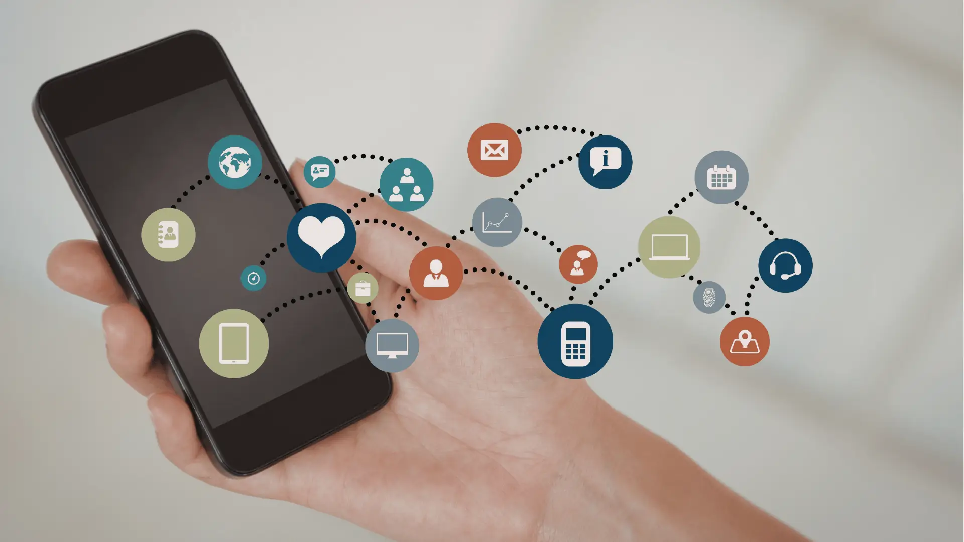 Hand holding smartphone with floating interconnected app and communication icons overlayed