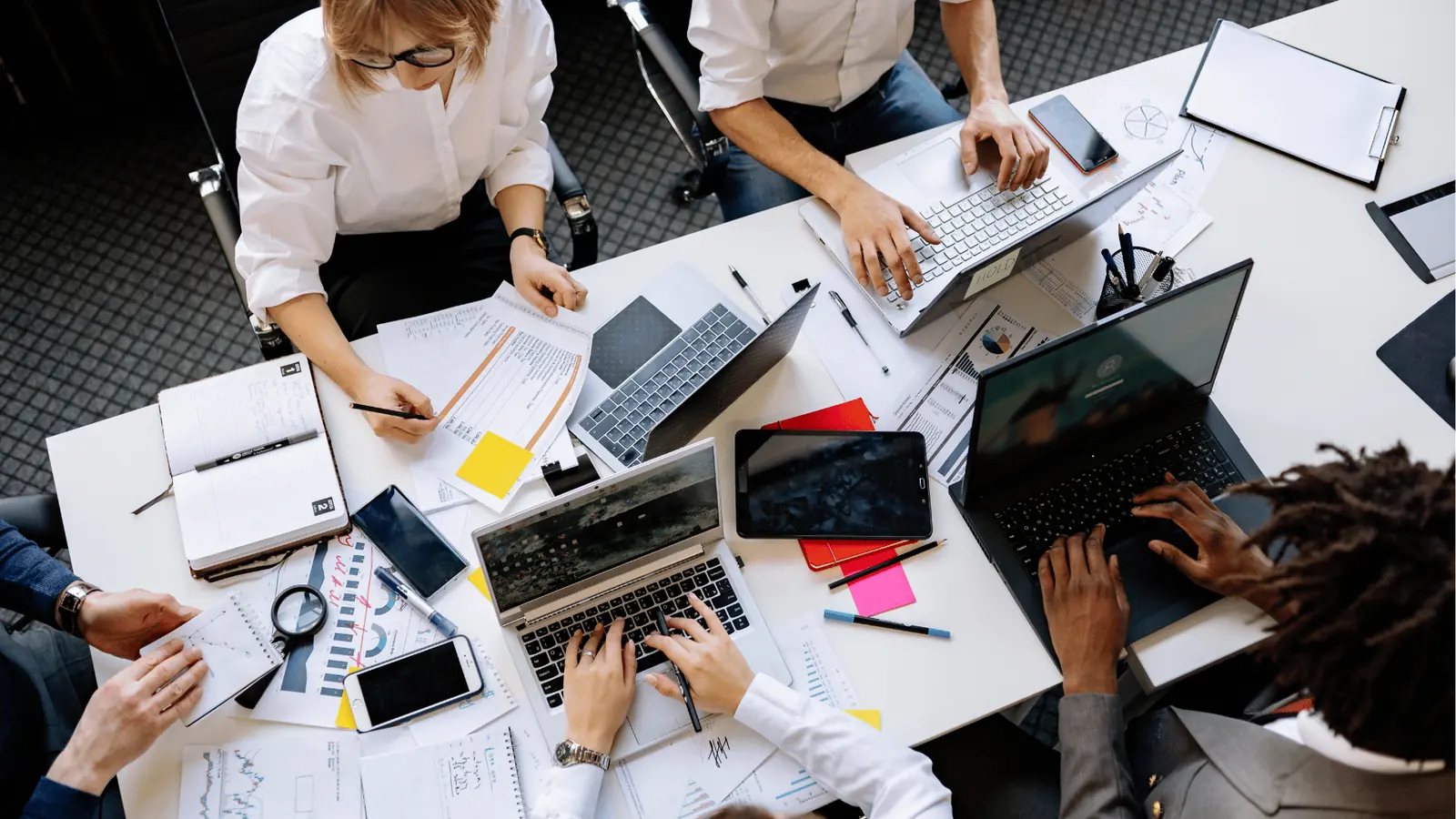 Enterprise social media team reviewing why the old way breaks once volume rises in a collaborative workspace