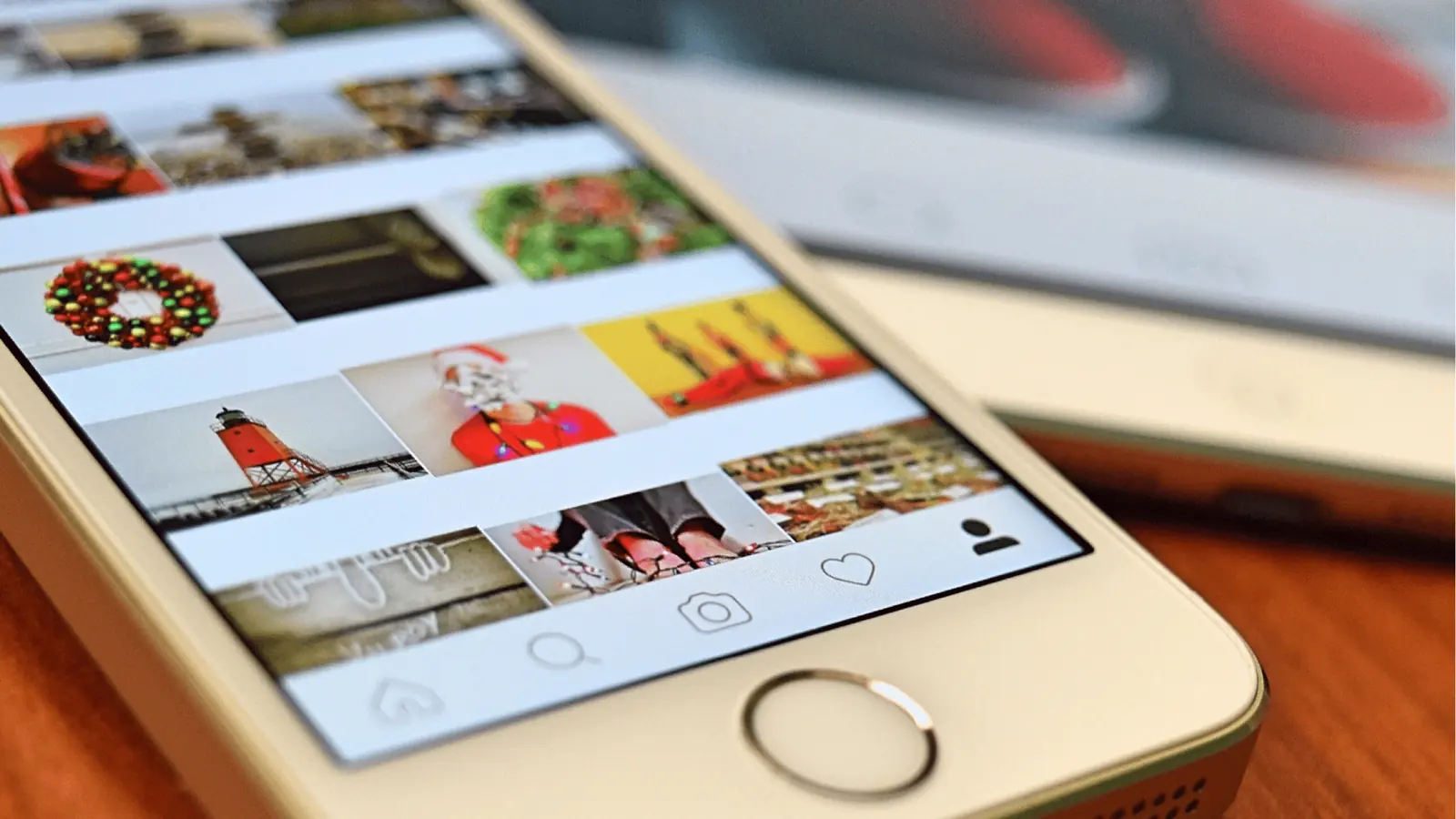Close-up of smartphone showing a social media photo grid and navigation icons for approval workflow
