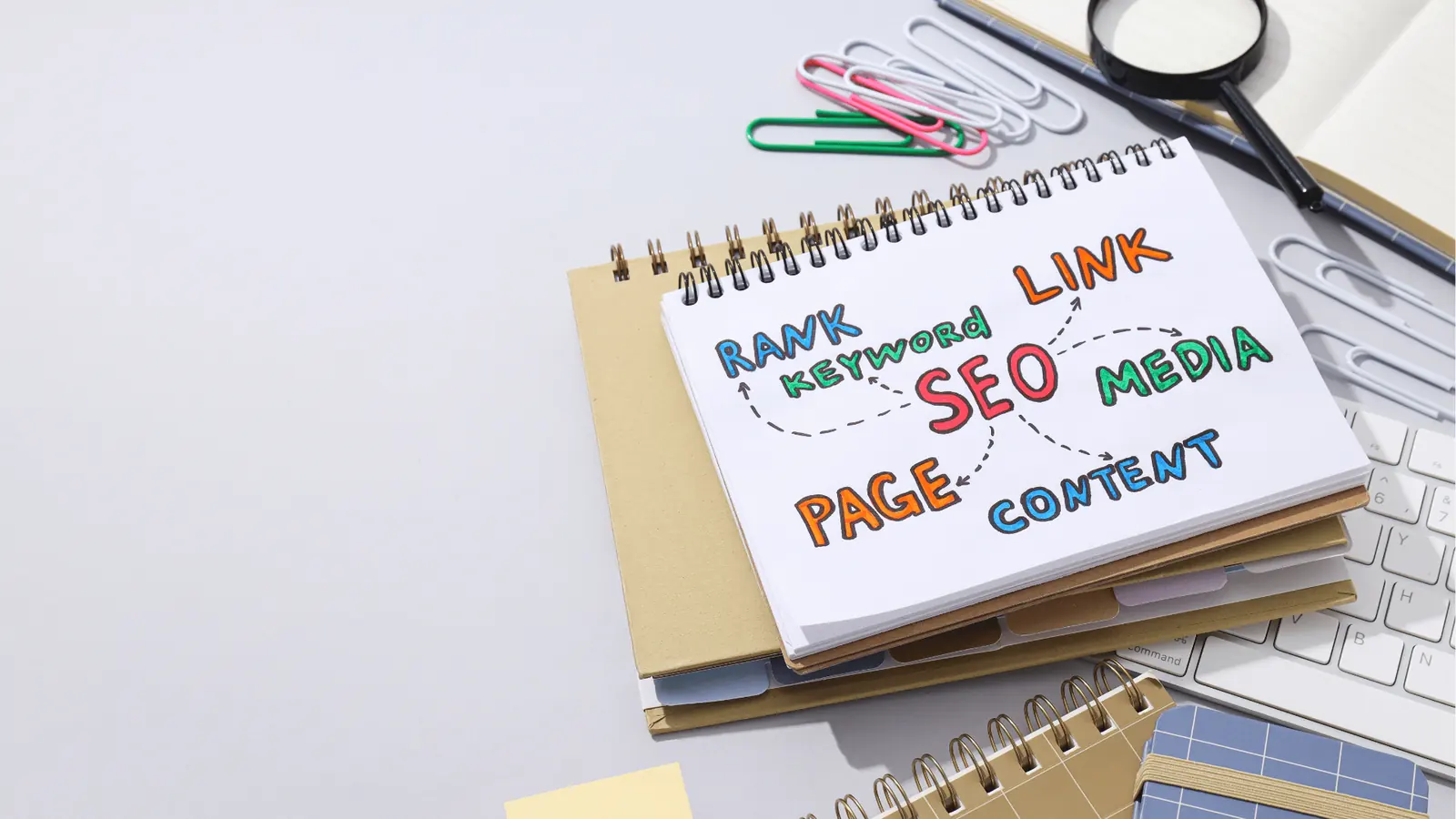 Spiral notebook on desk with colorful hand-drawn SEO mind map