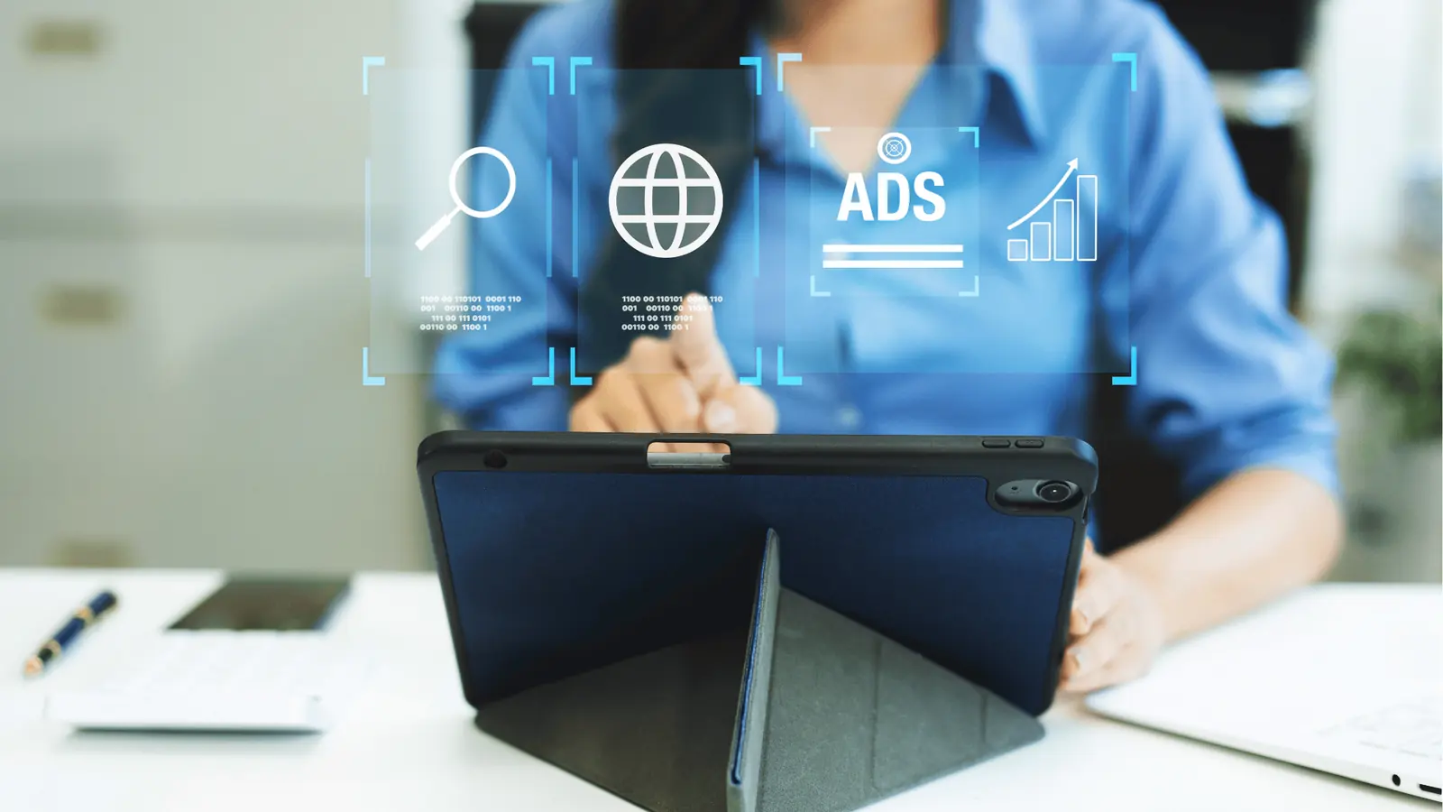 Person tapping a tablet with overlaid digital ads and web icons